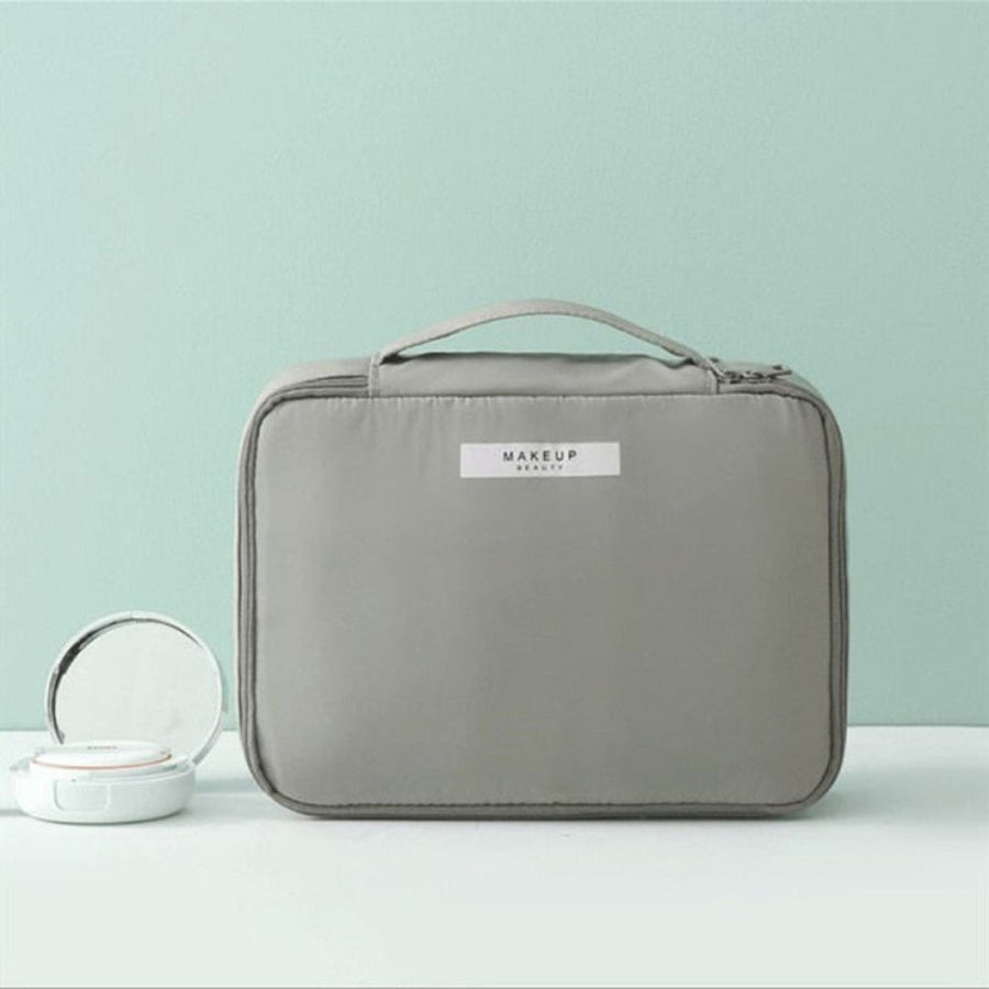 Gray makeup bag with 'MAKEUP' label on a light green background