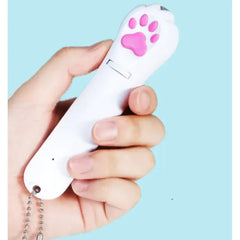 Hand holding a white remote control with a pink paw print on a light blue background