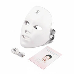 White LED face mask with cable and user manual on a white background