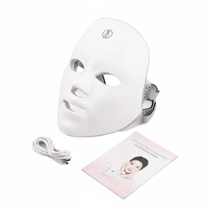 White LED face mask with cable and user manual on a white background