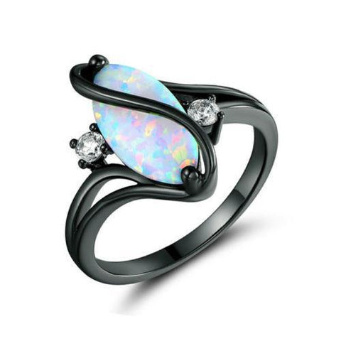 Black-rimmed ring with a colorful opal stone and smaller gemstones on a white background