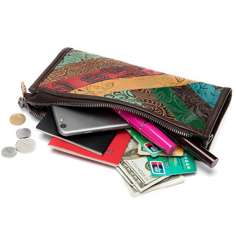 Multicolored patterned wallet with phone, cards, and coins on a white background