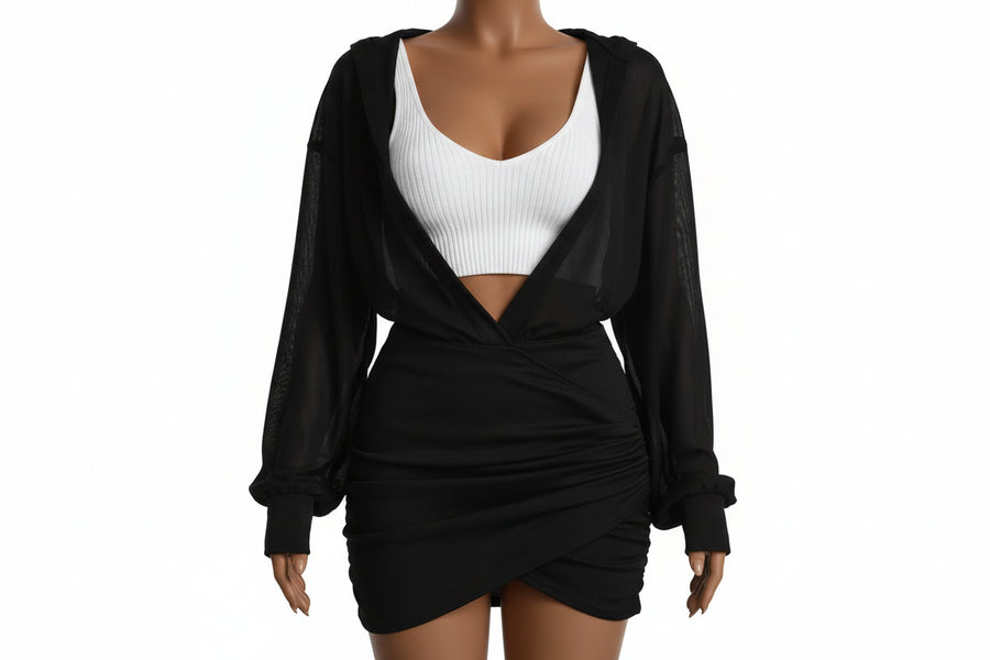 Person wearing a black robe over a white bra and panties on a neutral background