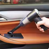 Person using a car interior cleaning tool to clean a car door panel.
